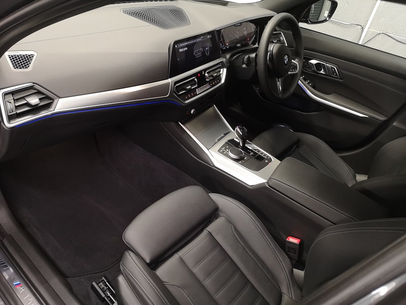 BMW 340i interior picture with black leather trim and contrasting aluminum fascias. 